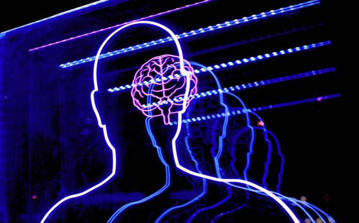 Photo of a layered light display depicting the outline of a human head and brain